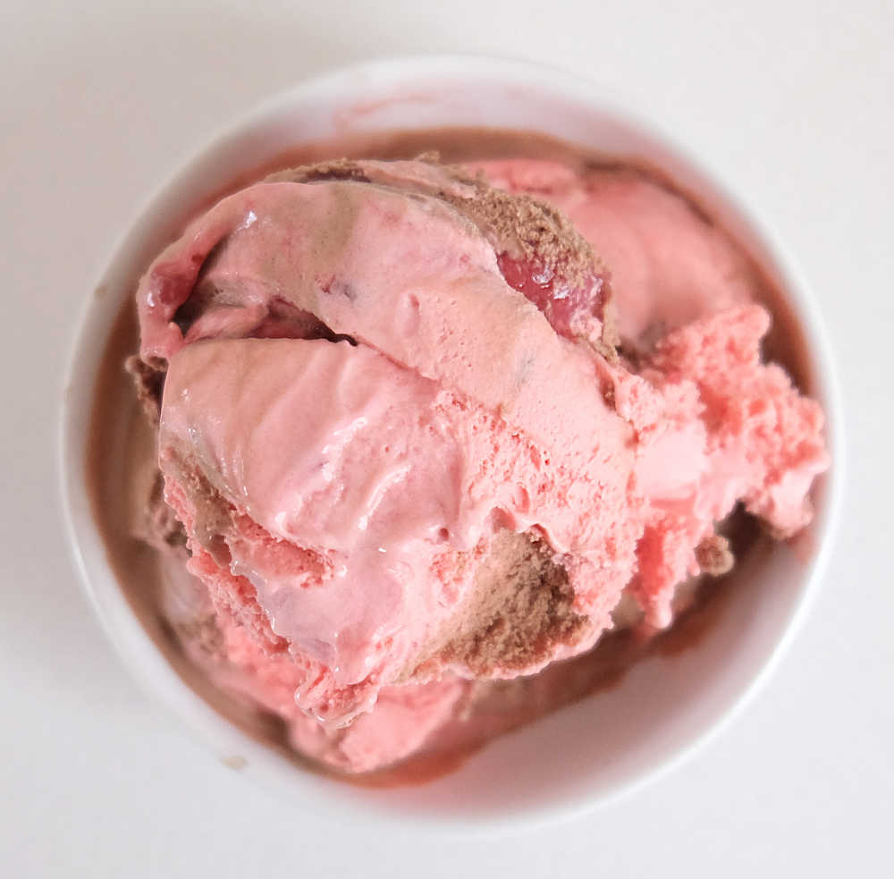 Top down photo of a bowl of Hershey's Chocolate-Strawberry Ripple Ice Cream.