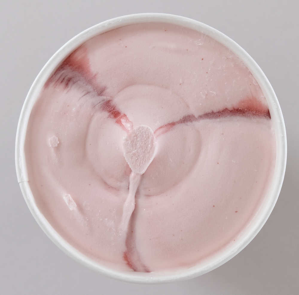 An unscooped pack of Connoisseur Gourmet Ice Cream Camarosa Strawberry.